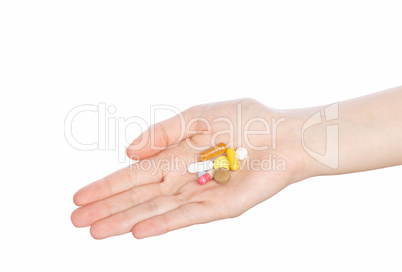 Woman hand holding pills on white