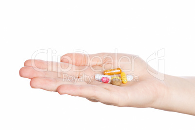 Woman hand holding pills on white