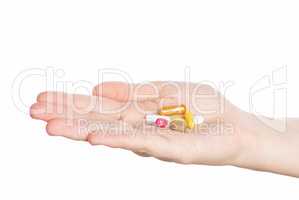 Woman hand holding pills on white