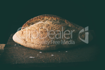 Baked white wheat flour oval crispbread on a wooden board
