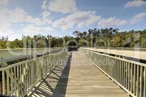 Blue sky and clouds over a bridge that crosses Henderson Creek,