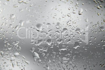 Rain drops on the glass window surface.