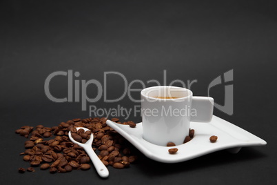 Cup of Coffe and coffee beans on black  background