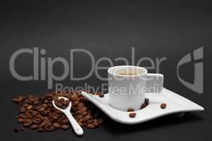 Cup of Coffe and coffee beans on black  background