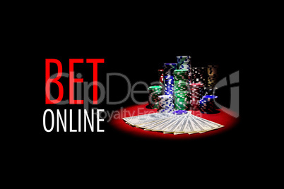 Poker cards , dollars and gambling chips on red table with message BET ONLINE