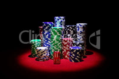 Red Dices with a lot of gambling chips on red casino table