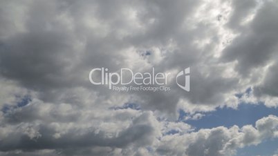 Time lapse clip of white fluffy clouds over blue sky