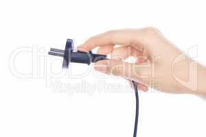 Woman hand holding black male wire plug isolated on white