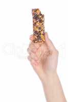 Woman holding grain cereal bar on white