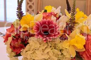 Spring bouquet of pink Gerbera daisies, yellow daffodils, orange