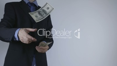 Businessman throws money into camera
