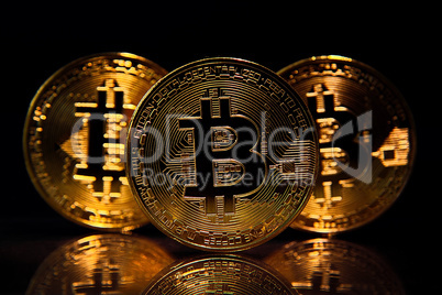Three Bitcoins isolated on black