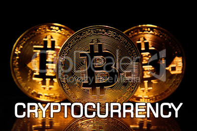 Bitcoins isolated on black with text CRYPTOCURRENCY