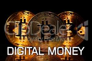 Bitcoins isolated on black with text DIGITAL MONEY