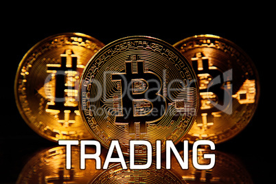 Bitcoins isolated on black with text  TRADING