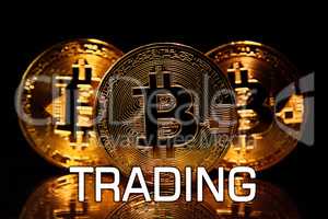 Bitcoins isolated on black with text  TRADING