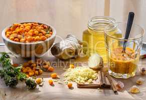 Squeezed sea-buckthorn berries in glass with other ingredients for healthy tea