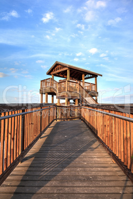 Bird observation tower at the end of a boardwalk at sunrise on T