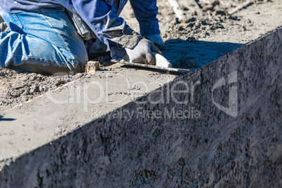 Pool Construction Worker Working With Wood Float On Wet Concrete