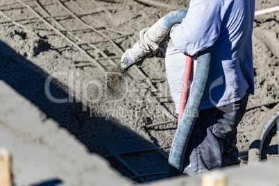 Pool Construction Worker Shooting Concrete, Shotcrete or Gunite