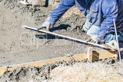 Pool Construction Worker Working With A Smoother Rod On Wet Concrete