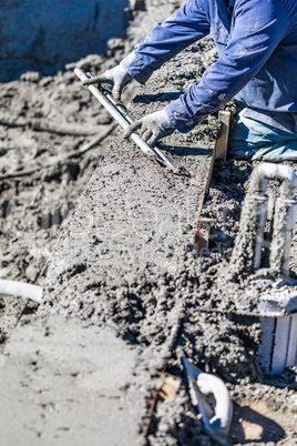 Pool Construction Worker Working With A Smoother Rod On Wet Concrete