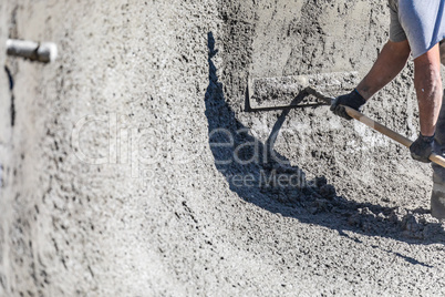 Pool Construction Worker Working With A Bullfloat On Wet Concrete