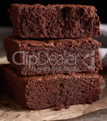 stack of baked square pieces of chocolate brownie cake