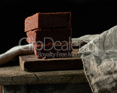 stack of baked square pieces of chocolate brownie cake