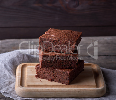 stack of baked square pieces of chocolate brownie cake