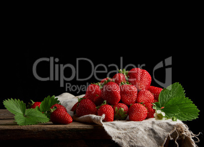 bunch of fresh ripe red strawberries on a gray linen napkin