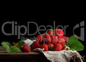 bunch of fresh ripe red strawberries on a gray linen napkin