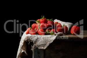 bunch of fresh ripe red strawberries on a gray linen napkin