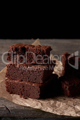 stack of baked square pieces of chocolate brownie cake