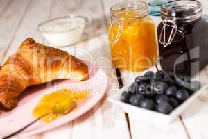 Breakfast with croissant over a wooden table