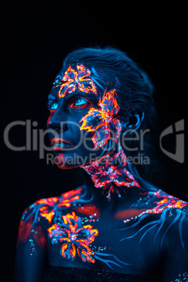 Beautiful flowers in UV light on a young girl face and body