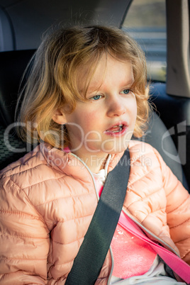 Child sits strapped in the car
