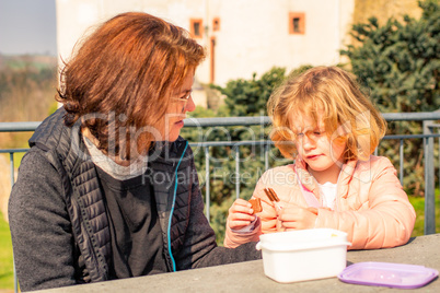 Woman with child picnic on castle Scharfenstein