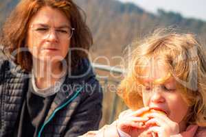 Woman with child picnic on castle Scharfenstein