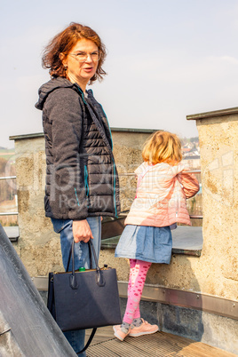 Woman with child in front of Scharfenstein Castle in the Erzgebirge