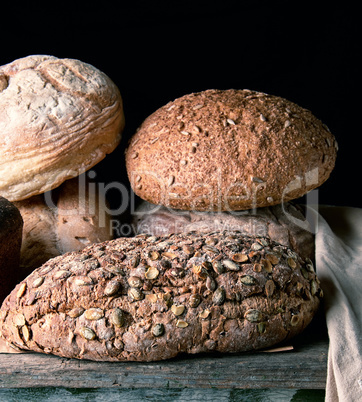 baked various breads , black  background
