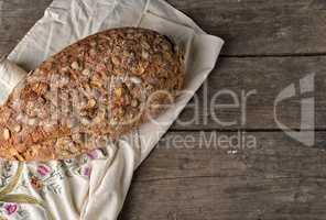 baked oval bread made from rye flour with pumpkin seeds