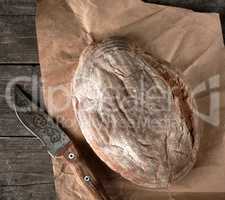 baked crisp oval bread and vintage knife