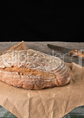 baked oval rye bread on a brown paper