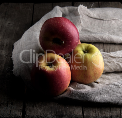 fresh red apples lies on a gray linen napkin