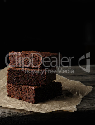 stack of baked square pieces of chocolate brownie cake