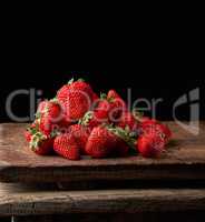 bunch of fresh ripe red strawberries on a  wooden table