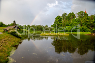 Rainbow over the trees and pond