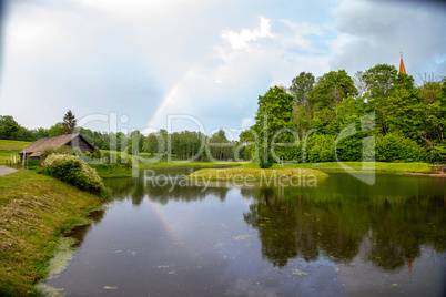 Rainbow over the trees and pond