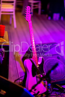 Guitar and sound amplifier in abstract light